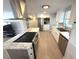 Well-lit kitchen with stainless steel appliances, marble countertops and white cabinets at 177 Palm Harbor Dr, North Port, FL 34287