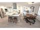 Open kitchen with marble countertops, a stainless steel refrigerator and a dining area at 177 Palm Harbor Dr, North Port, FL 34287