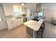 Lovely kitchen with white cabinets, marble countertops, an island cooktop and eat-in dining at 177 Palm Harbor Dr, North Port, FL 34287