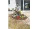 Up close, colorful landscaping complements this home’s covered entryway and well-kept lawn at 177 Palm Harbor Dr, North Port, FL 34287