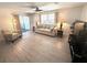 Bright living room featuring a ceiling fan, neutral walls and vinyl floors at 177 Palm Harbor Dr, North Port, FL 34287