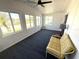 Bright sun room with ample windows, a ceiling fan, and comfortable seating at 177 Palm Harbor Dr, North Port, FL 34287