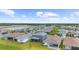 Beautiful aerial view of a residential community featuring single-Gathering homes, lush greenery, and scenic ponds in the background at 18001 Grand Prosperity Dr, Venice, FL 34293