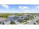 Aerial view of a two-story home, showcasing a well-maintained lawn, brick-paved driveway, and nearby street at 18001 Grand Prosperity Dr, Venice, FL 34293