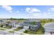 Aerial view of a two-story home highlighting the well-kept lawn, complemented by a brick-paved driveway at 18001 Grand Prosperity Dr, Venice, FL 34293