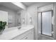 Bright bathroom featuring a quartz countertop vanity and shower with glass doors at 18001 Grand Prosperity Dr, Venice, FL 34293