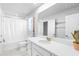 Bright bathroom featuring white cabinets, quartz countertop, and tub with shower at 18001 Grand Prosperity Dr, Venice, FL 34293