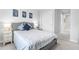 Stylish bedroom with a comfortable bed, decorative pillows, and a matching nightstand with lamp at 18001 Grand Prosperity Dr, Venice, FL 34293