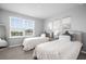 Charming bedroom with twin beds, decorative artwork, soft pillows, and a view of the outdoors at 18001 Grand Prosperity Dr, Venice, FL 34293