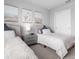 Comfortable bedroom featuring twin beds, stylish wall art, and matching nightstands with modern lamps at 18001 Grand Prosperity Dr, Venice, FL 34293