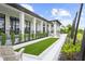 Stunning clubhouse exterior featuring a turfed lawn and plenty of outdoor seating for residents to gather and socialize at 18001 Grand Prosperity Dr, Venice, FL 34293