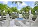 Outdoor fire pit area with lounge seating and picturesque landscaping perfect for relaxing with friends at 18001 Grand Prosperity Dr, Venice, FL 34293
