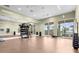 Bright and airy fitness center features weights, mirrors, and windows with neighborhood views at 18001 Grand Prosperity Dr, Venice, FL 34293