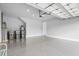 Spacious and clean garage featuring a gray epoxy floor and ample lighting at 18001 Grand Prosperity Dr, Venice, FL 34293