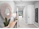 Inviting hallway with neutral tones, featuring a decorative mirror, stylish console table, and a glimpse into the living area at 18001 Grand Prosperity Dr, Venice, FL 34293