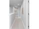 Spacious hallway with neutral tile flooring, recessed lighting, and walls, perfect for a modern home interior at 18001 Grand Prosperity Dr, Venice, FL 34293