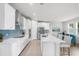 Well-lit kitchen features a large island with bar seating, stainless steel appliances, and plenty of cabinet space at 18001 Grand Prosperity Dr, Venice, FL 34293
