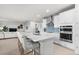 Spacious kitchen with a large center island, seating, modern appliances, stylish backsplash and an open layout at 18001 Grand Prosperity Dr, Venice, FL 34293