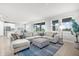 Bright and spacious living room featuring a large sectional sofa, neutral decor, and ample natural light at 18001 Grand Prosperity Dr, Venice, FL 34293
