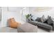 Cozy living room with gray sofa, leather beanbag chair, and access to the bright, modern bathroom at 18001 Grand Prosperity Dr, Venice, FL 34293