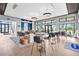 Spacious clubhouse lounge with stylish seating, modern lighting, and floor-to-ceiling windows at 18001 Grand Prosperity Dr, Venice, FL 34293