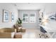 Inviting office with wicker chairs, neutral walls, artwork, and a sleek white desk creates a calming workspace at 18001 Grand Prosperity Dr, Venice, FL 34293