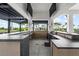 Well-equipped outdoor kitchen features stone countertops, stainless steel appliances, and a functional design at 18001 Grand Prosperity Dr, Venice, FL 34293