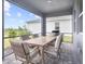Screened patio featuring dining table with four chairs overlooking landscaped backyard at 18001 Grand Prosperity Dr, Venice, FL 34293