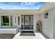 Inviting entryway with stylish front door, decorative wreath, and charming accents at 18380 Robinson Ave, Port Charlotte, FL 33948