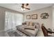 Relaxing home office setup with a couch and ample space for work, complemented by a ceiling fan at 18380 Robinson Ave, Port Charlotte, FL 33948