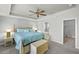 This main bedroom boasts a ceiling fan, a sitting area, and an en suite bathroom at 1843 Oakland Rd, North Port, FL 34286