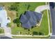 An aerial view of a home showcasing its backyard, driveway, landscaping, and the surrounding neighborhood at 2000 Jasmine Way, North Port, FL 34287