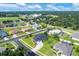 Aerial neighborhood view showcases landscaped properties, mature trees, ponds, and surrounding streets at 2000 Jasmine Way, North Port, FL 34287