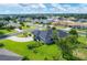 Aerial view of home featuring a manicured lawn and landscaping, mature shade trees, and a fenced-in backyard at 2000 Jasmine Way, North Port, FL 34287