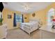 Serene bedroom with neutral carpet, a decorative ceiling fan, and large windows for plenty of natural light at 2000 Jasmine Way, North Port, FL 34287