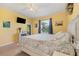 Bright bedroom with carpet flooring, a ceiling fan, and access to a covered patio area at 2000 Jasmine Way, North Port, FL 34287