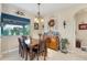 Cozy dining room showcasing a wooden dining table, decorative chandelier, and views of the backyard at 2000 Jasmine Way, North Port, FL 34287