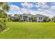Beautiful front yard features mature landscaping and a well-maintained lawn for curb appeal at 2000 Jasmine Way, North Port, FL 34287