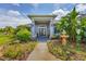 Grand front entrance features double doors, lovely landscaping, and an inviting walkway at 2000 Jasmine Way, North Port, FL 34287