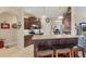 Stylish kitchen with granite countertops, wood cabinets, stainless appliances, and a breakfast bar with seating at 2000 Jasmine Way, North Port, FL 34287