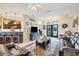 Inviting living room with dark leather furniture, tile flooring, and an open layout with views into the kitchen at 2000 Jasmine Way, North Port, FL 34287