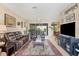 Open-concept living room features comfortable seating, an entertainment center, and lots of natural light at 2000 Jasmine Way, North Port, FL 34287