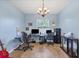 Comfortable office space with hardwood floors, natural light, and furniture to create a productive workspace at 2000 Jasmine Way, North Port, FL 34287
