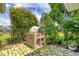 Backyard pizza oven featuring brick construction, stone base, and lush landscaping at 2000 Jasmine Way, North Port, FL 34287