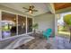Comfortable covered patio with slate flooring, a ceiling fan, and sliding glass doors leading to the interior at 2000 Jasmine Way, North Port, FL 34287