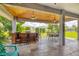 Spacious covered patio features a wood-paneled ceiling, an outdoor kitchen, and ample seating for dining at 2000 Jasmine Way, North Port, FL 34287