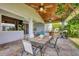 Inviting covered patio boasts a wood ceiling, ceiling fans, an outdoor grill, and a pizza oven at 2000 Jasmine Way, North Port, FL 34287