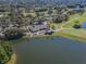 Scenic aerial view of the clubhouse, golf course, and lake offering a glimpse of luxury living at 2022 Calusa Lakes Blvd, Nokomis, FL 34275