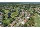 Aerial view of a golf course community with a single-Gathering home outlined in white at 2022 Calusa Lakes Blvd, Nokomis, FL 34275