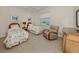 Comfortable bedroom with twin beds, recliner, and neutral tones at 2022 Calusa Lakes Blvd, Nokomis, FL 34275